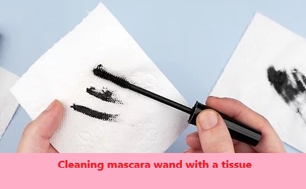 Cleaning mascara wand with a tissue