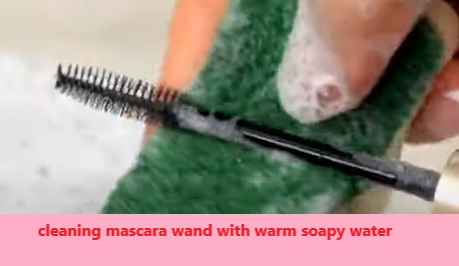 cleaning mascara wand with warm soapy water