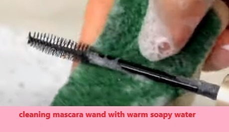 cleaning mascara wand with warm soapy water